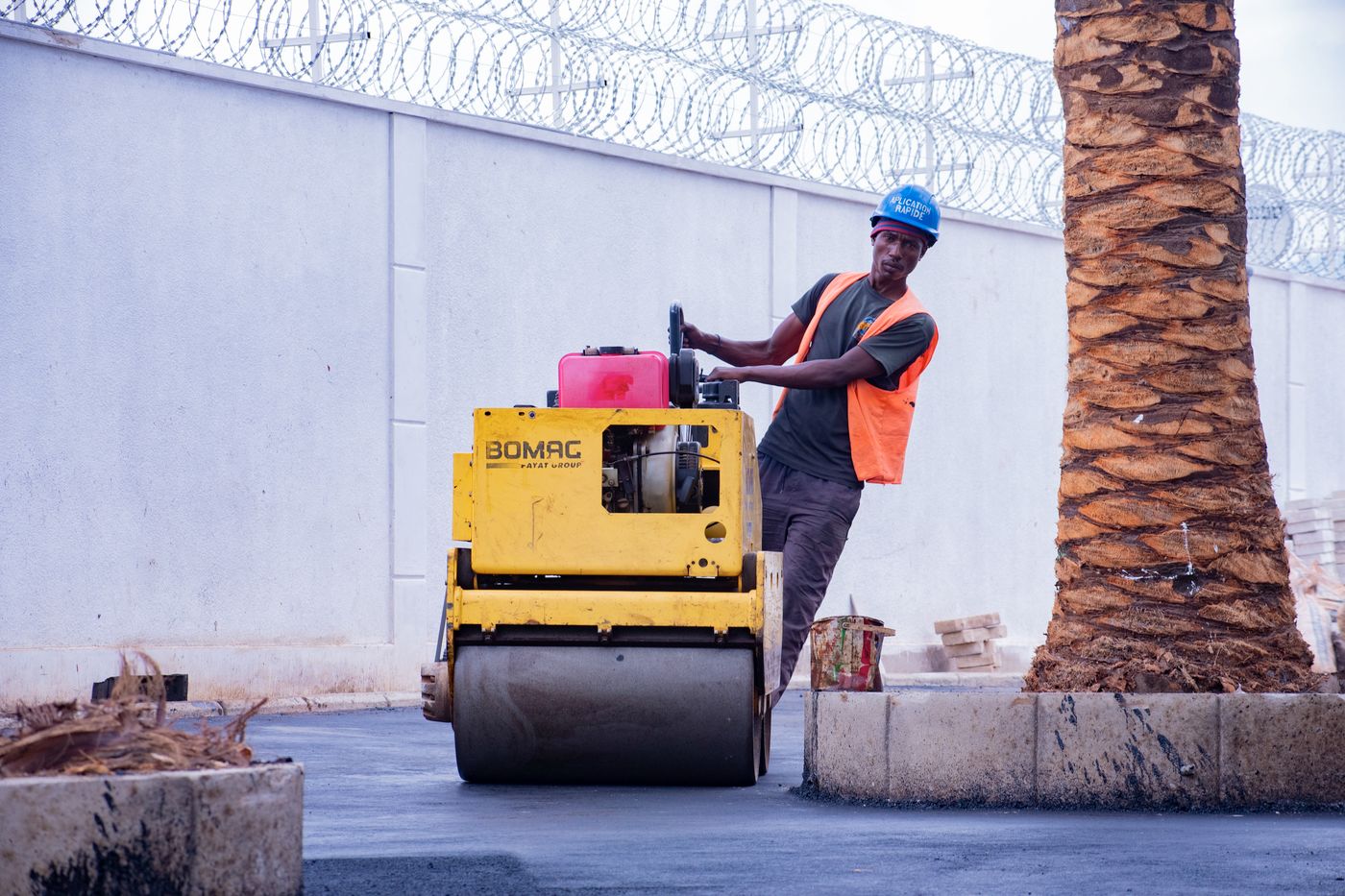Road roller compacting a newly laid asphalt surface — reference photo